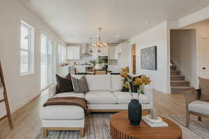 Living area featuring hanging lights and light wood-type flooring