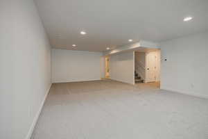 Empty room featuring light carpet and recessed lighting