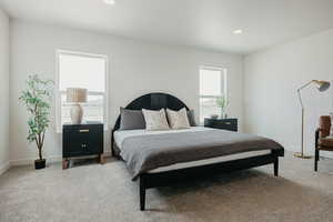 Bedroom with light carpet and recessed lighting