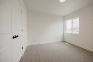 Unfurnished bedroom featuring light colored carpet and a closet
