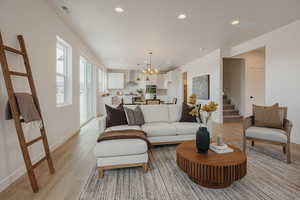 Living room with hanging lights and light wood finished floors