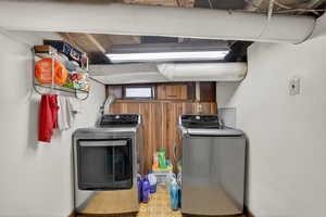 Laundry area featuring washer and clothes dryer and light flooring