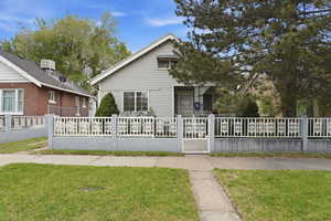 Bungalow-style home featuring a fenced front yard
