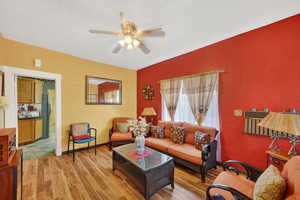 Living area with a ceiling fan and light wood-type flooring
