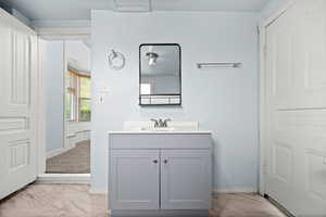 Bathroom with light marble finish floors and vanity