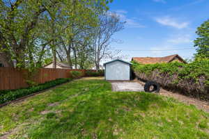 Fenced backyard with a storage unit