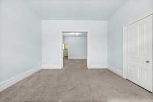 Empty room with baseboards and carpet