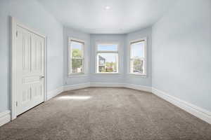 Carpeted empty room with baseboards