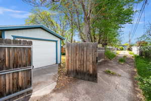 Garage with concrete driveway and a gate