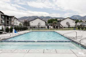 Community pool featuring a mountain view, a patio area, and a residential view