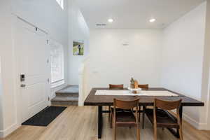 Dining space with light wood-style flooring and recessed lighting