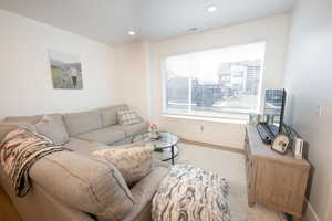 Living area featuring baseboards and recessed lighting