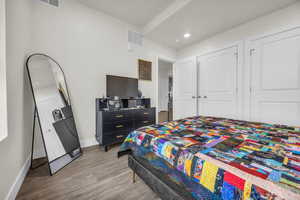 Bedroom featuring wood finished floors, a closet, and recessed lighting