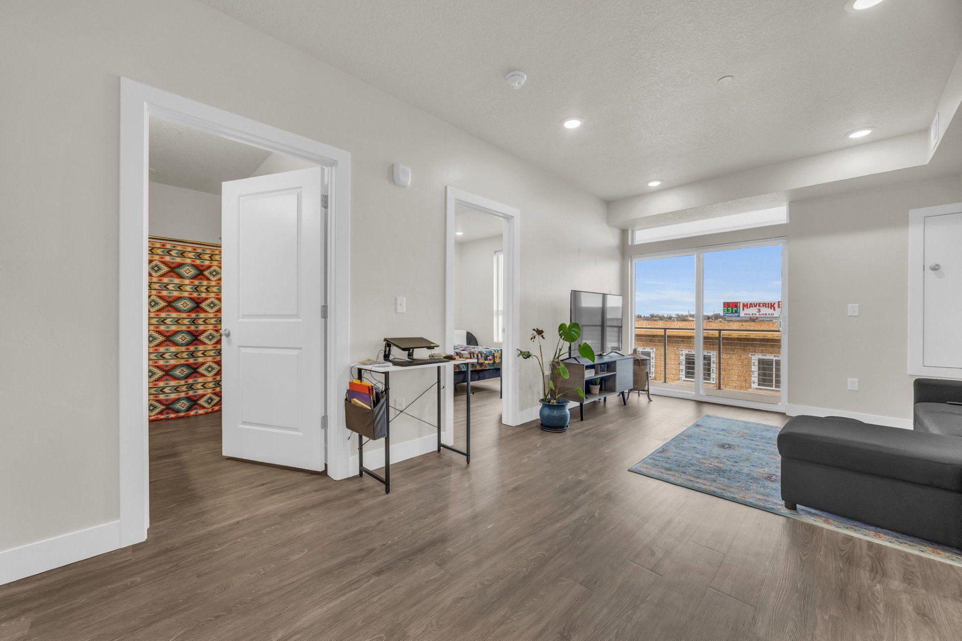 Living room featuring dark wood-type flooring and recessed lighting