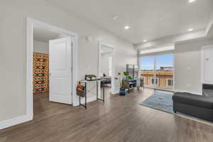 Living room featuring dark wood-type flooring and recessed lighting