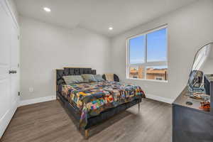 Bedroom featuring wood finished floors and recessed lighting