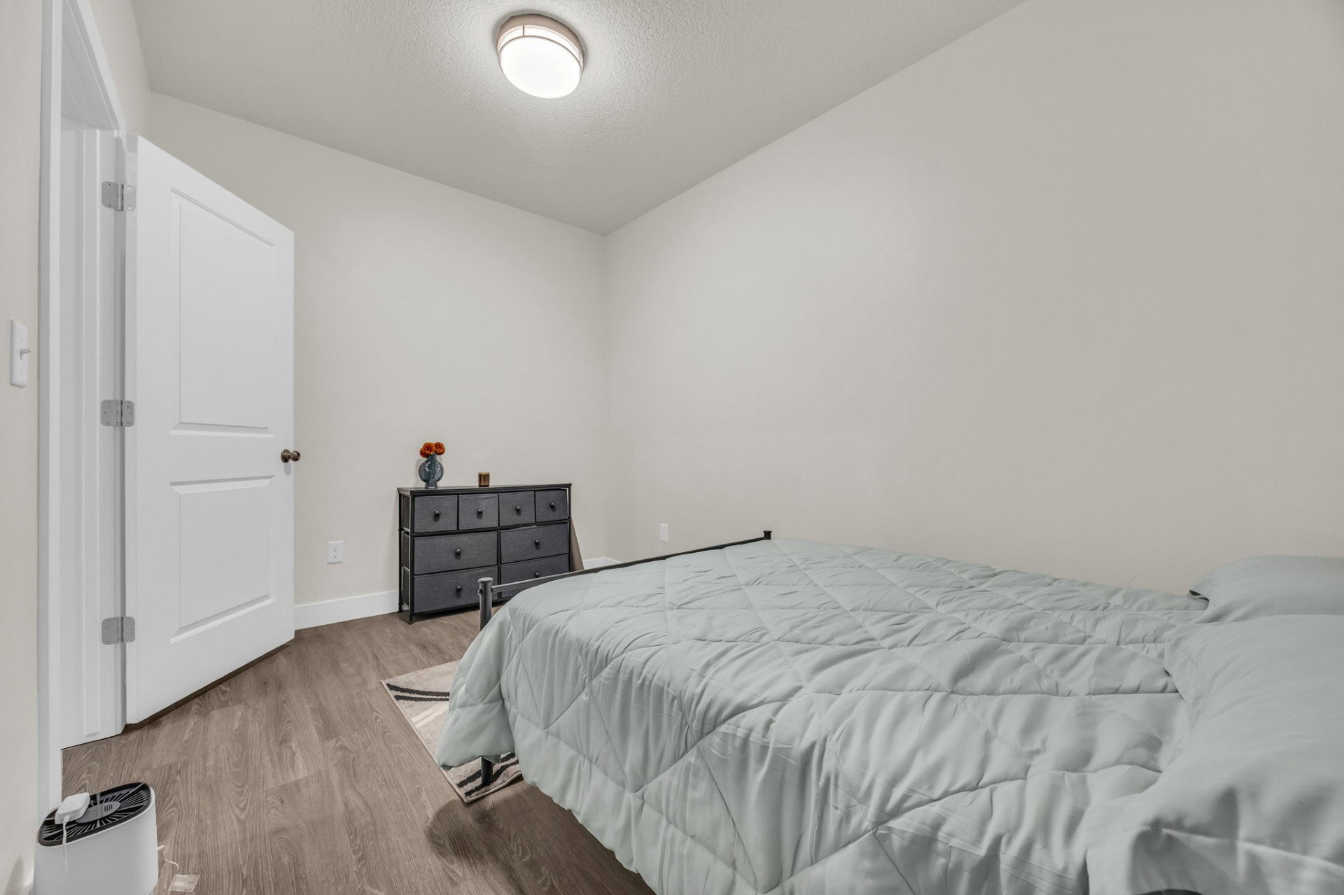 Bedroom featuring wood finished floors and a textured ceiling