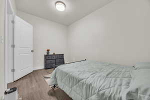 Bedroom featuring wood finished floors and a textured ceiling
