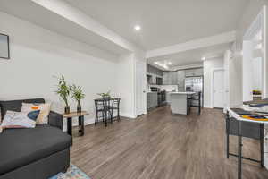 Living area with recessed lighting and dark wood finished floors