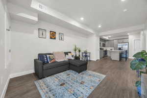 Living area featuring recessed lighting and dark wood finished floors