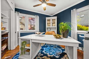 Office area with wood finished floors, ornamental molding, and ceiling fan
