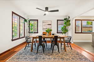 Dining room with wood finished floors and a ceiling fan