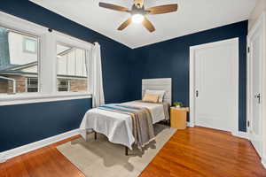 Bedroom featuring wood finished floors and ceiling fan