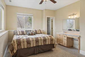 Bedroom with light carpet and a ceiling fan