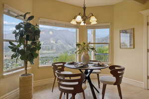 Dining area featuring a mountain view, suspended lighting, and light tile patterned floors