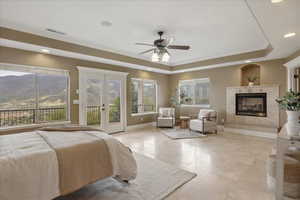 Bedroom featuring crown molding, french doors, a ceiling fan, a high end fireplace, and recessed lighting
