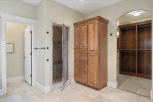 Bathroom featuring a stall shower and light tile patterned floors