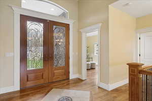 Foyer featuring light wood-type flooring and french doors