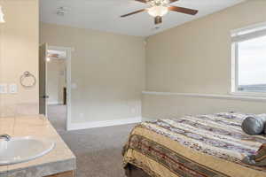 Bedroom featuring light colored carpet and ceiling fan