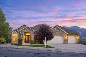 French country style house with stone siding, french doors, an attached garage, and concrete driveway