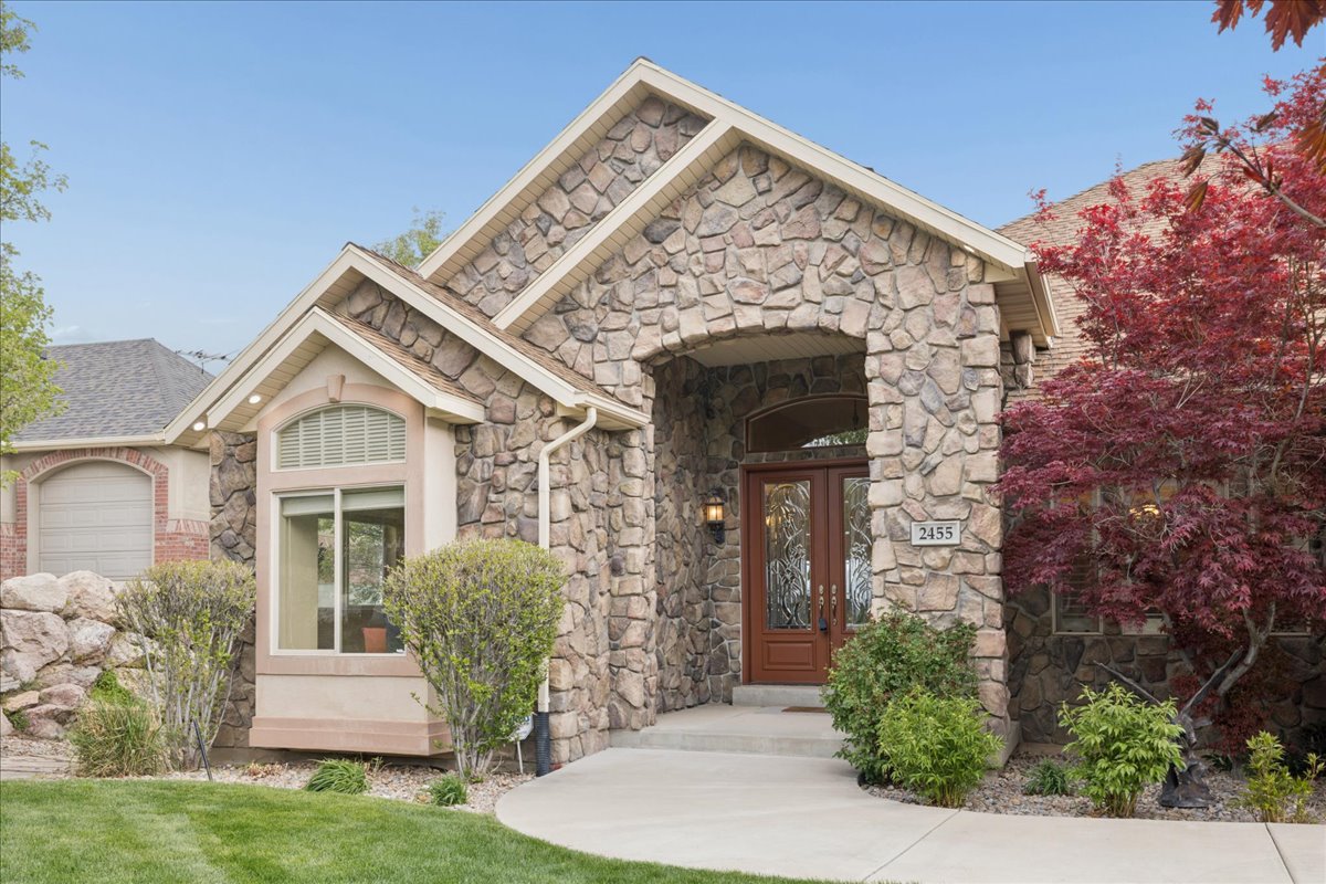 View of exterior entry featuring stone siding