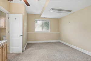 Unfurnished bedroom with light carpet and ceiling fan