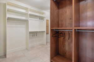 Walk in closet featuring light tile patterned flooring