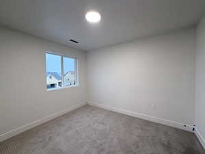 Spare room with carpet flooring and baseboards