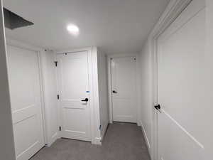 Hallway featuring dark carpet and recessed lighting