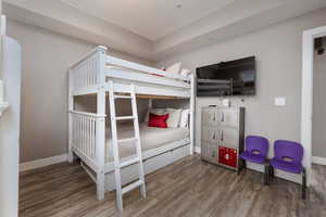 Bedroom featuring wood finished floors and baseboards