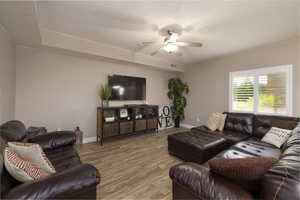 Living area featuring ceiling fan and wood finished floors
