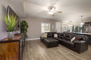 Living area with a ceiling fan and wood finished floors