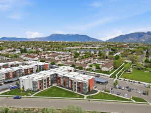 Aerial view of a mountain backdrop and apartment complex / building