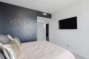 Carpeted bedroom featuring baseboards