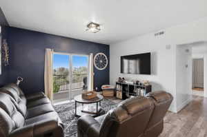 Living room featuring wood finished floors and a textured ceiling