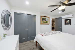 Bedroom with a closet, light wood finished floors, recessed lighting, and ceiling fan