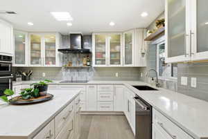 Kitchen featuring open shelves, light stone countertops, white cabinets, light wood-style floors, and recessed lighting