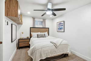 Bedroom featuring ceiling fan, dark colored carpet, and recessed lighting