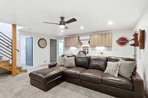 Living room with a ceiling fan, light colored carpet, and recessed lighting