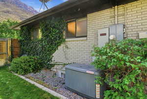 View of property exterior with brick siding and a mountain view